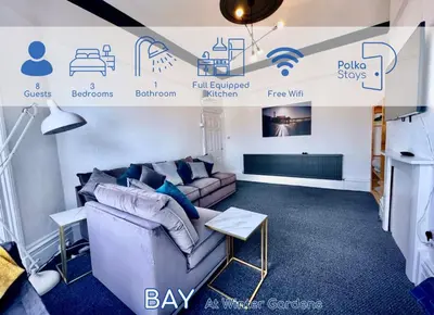 a living room with a couch and a tv at PolkaDot Winter Gardens - Large Modern Apartments in Blackpool by PolkaStays in Blackpool