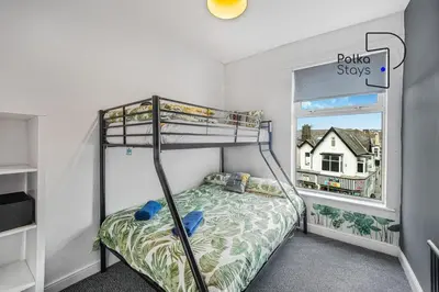a bedroom with a bunk bed and a window at PolkaDot Winter Gardens - Large Modern Apartments in Blackpool by PolkaStays in Blackpool