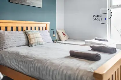 a bedroom with a bed with two pillows on it at PolkaDot Winter Gardens - Large Modern Apartments in Blackpool by PolkaStays in Blackpool