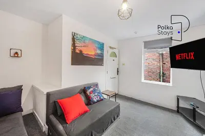 a living room with a couch and a tv at PolkaDot Winter Gardens - Large Modern Apartments in Blackpool by PolkaStays in Blackpool