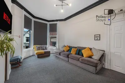 a living room with a couch and two chairs at PolkaDot Winter Gardens - Large Modern Apartments in Blackpool by PolkaStays in Blackpool