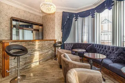 a bar with a couch and chairs and tables at Cherry Tree House in Blackpool