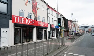 a k pop end sign on the side of a building at The Kop End Hotel by Serviced Living Liverpool in Liverpool