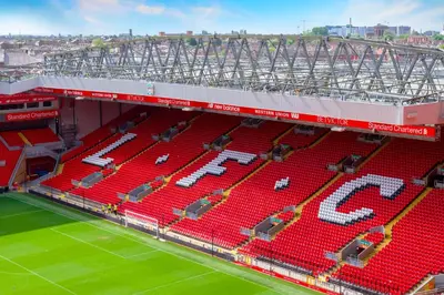 an aerial view of a soccer stadium with red seats at The Kop End Hotel by Serviced Living Liverpool in Liverpool