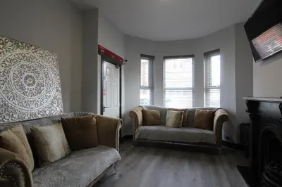 a living room with two couches and a tv at Anfield house in Liverpool