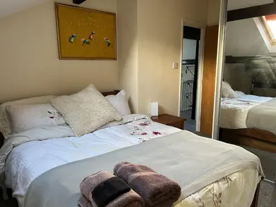 a bedroom with a bed with towels on it at Arnside sea view in Arnside