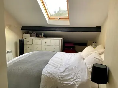 a bedroom with a white bed and a window at Arnside sea view in Arnside