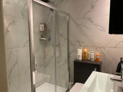 a bathroom with a shower and a toilet and a sink at Arnside sea view in Arnside