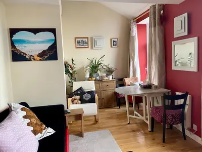 a living room with a table and a dining room at Arnside sea view in Arnside