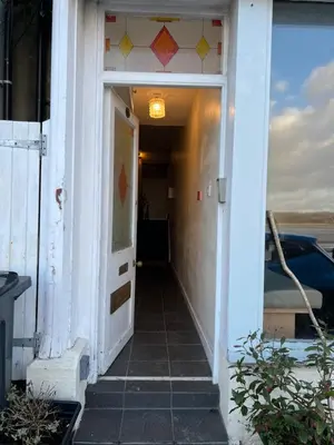 a hallway of a house with a door open at Arnside sea view in Arnside