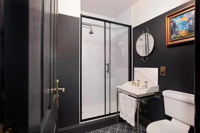 a bathroom with a sink and a shower at Swan & Railway Hotel Wigan in Wigan