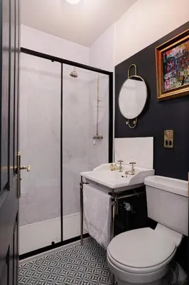 a bathroom with a shower and a toilet and a sink at Swan & Railway Hotel Wigan in Wigan