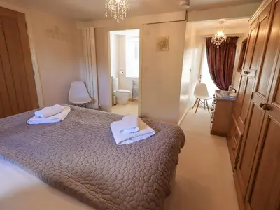 a bedroom with a bed with two towels on it at Clock Tower in Grange Over Sands