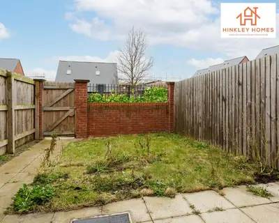 a backyard with a wooden fence and a grassy yard at Newbuild 4bed - City Centre - Free secure parking! By Hinkley Homes Short Lets & Serviced Accommodation in Liverpool