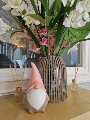 a vase with flowers in it sitting on a table at The Bosworth House Hotel in Blackpool