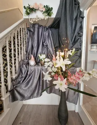 a vase of flowers on a staircase with a curtain at The Bosworth House Hotel in Blackpool