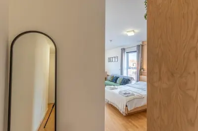 a bedroom with a mirror and a bed in a room at Cosy Studio in Merseyside in Great Location in Liverpool