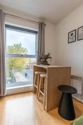 a kitchen with a counter and a large window at Cosy Studio in Merseyside in Great Location in Liverpool