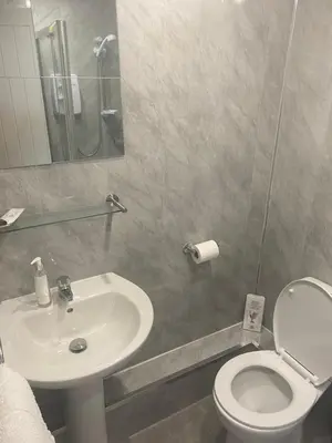 a bathroom with a white toilet and a sink at The Cosy Nook in Blackpool