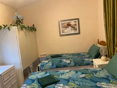 a room with two beds and a mirror at CHARLES INN in Liverpool