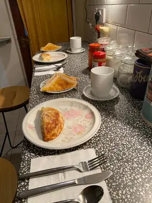 a table with plates of food and utensils on it at CHARLES INN in Liverpool