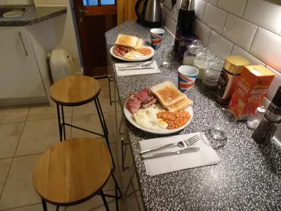 two plates of breakfast food on a counter in a kitchen at CHARLES INN in Liverpool