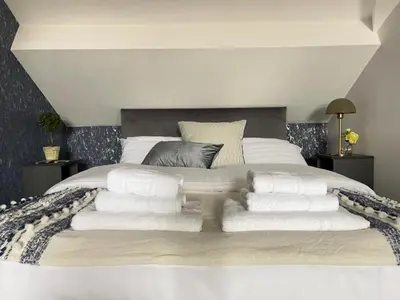 a bedroom with a large bed with towels on it at Room 4 (8 Holland Street) in Liverpool