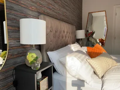 a bedroom with a bed with white pillows and a mirror at Room 4 (8 Holland Street) in Liverpool