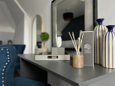 a desk with vases on it with a mirror at Room 4 (8 Holland Street) in Liverpool