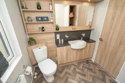 a bathroom with a toilet and a sink at Loluke Lodge on The Lake in Carnforth