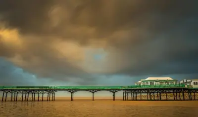 a pier on the water under a cloudy sky at 34 One in Lytham St Annes