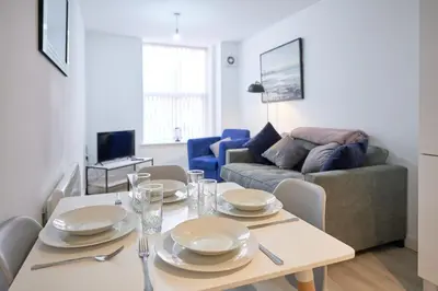 a living room with a table and a couch at Winkley House by Guestz in Preston