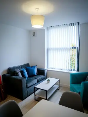 a living room with a couch and a table at Winkley House by Guestz in Preston