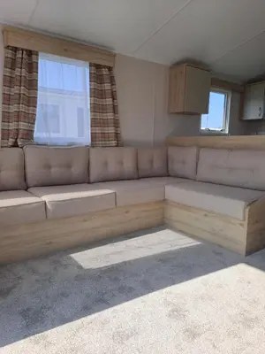 a couch in a living room with a window at Edwards Holiday Home in Blackpool