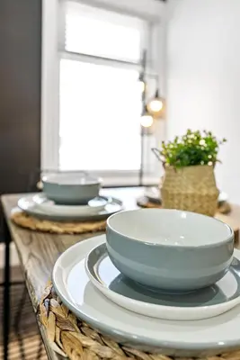 two bowls and plates sitting on a table at The Treehouse at The Hideaway STAMP SA in Blackpool