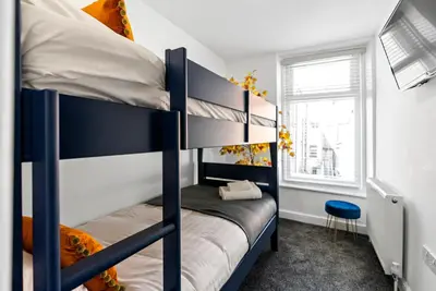 a bedroom with two bunk beds and a window at The Nest at The Hideaway STAMP SA in Blackpool