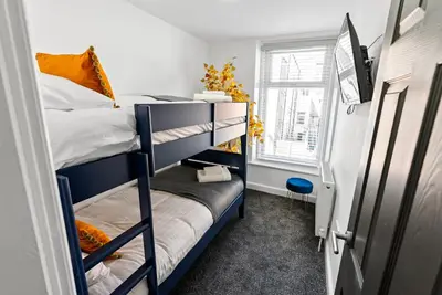 a dorm room with two bunk beds and a window at The Nest at The Hideaway STAMP SA in Blackpool
