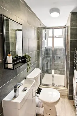 a bathroom with a toilet and a sink and a shower at The Nest at The Hideaway STAMP SA in Blackpool