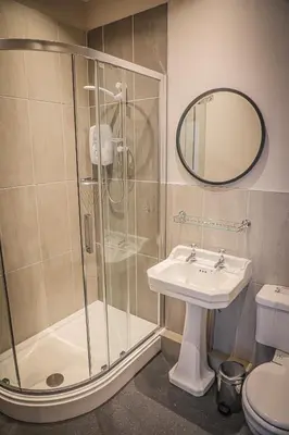 a bathroom with a shower and a sink at Hope and Anchor in Flookburgh
