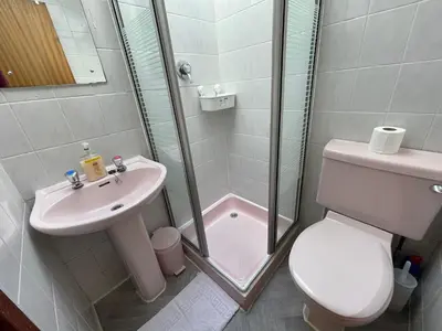 a bathroom with a shower and a toilet and a sink at Galaxy Hotel in Blackpool