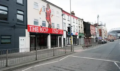 an empty street with a k pop end sign on a building at The Kop End Penthouse in Liverpool