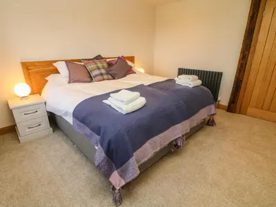 a bedroom with a large bed with towels on it at Lanshaw House in Lancaster