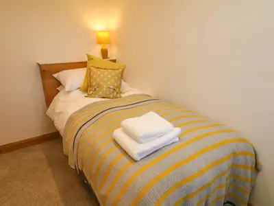 a bedroom with a bed with towels on it at Lanshaw House in Lancaster