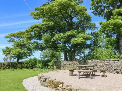 a picnic table in front of a stone wall at Lanshaw House in Lancaster