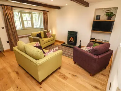 a living room with two couches and a fireplace at Lanshaw House in Lancaster