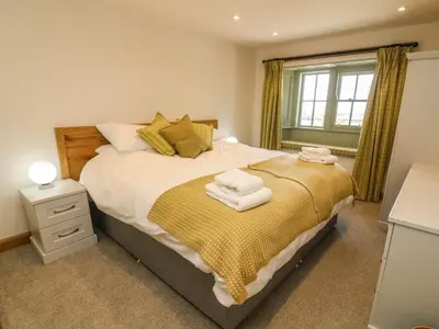 a bedroom with a bed with towels on it at Lanshaw House in Lancaster
