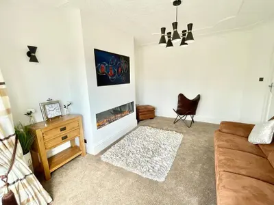 a living room with a couch and a fireplace at Croyden villa in Blackpool