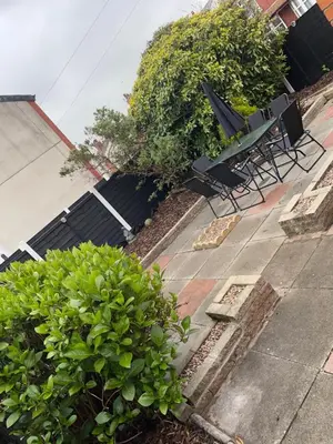 a group of chairs and bushes on a sidewalk at Croyden villa in Blackpool