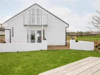 a white house with a lawn in front of it at The Annex in Ulverston