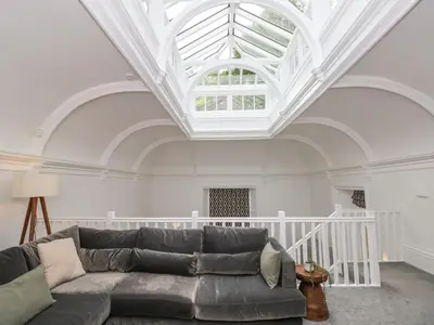 a living room with a couch and a ceiling at The Kennedy House Stone Cross Mansion in Ulverston